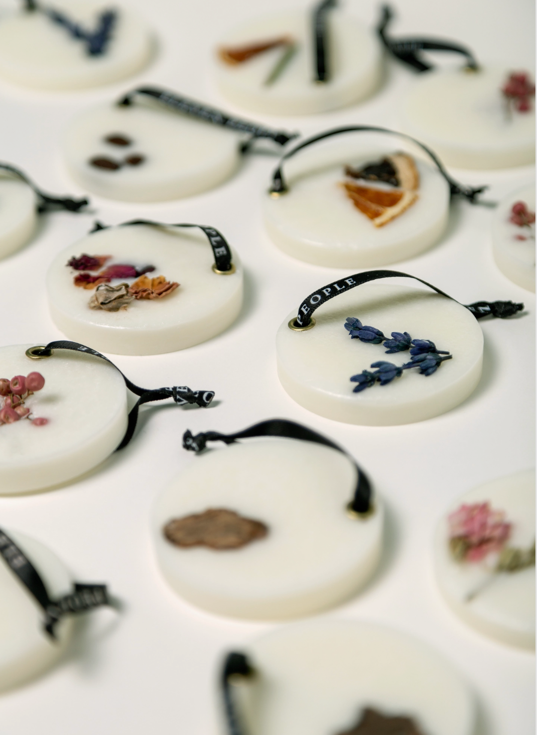 Decorative items with dried flowers and leaves on a white surface