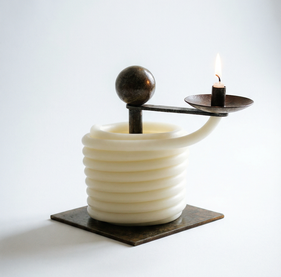 Candle holder with a white base and black metal design on a light gray background