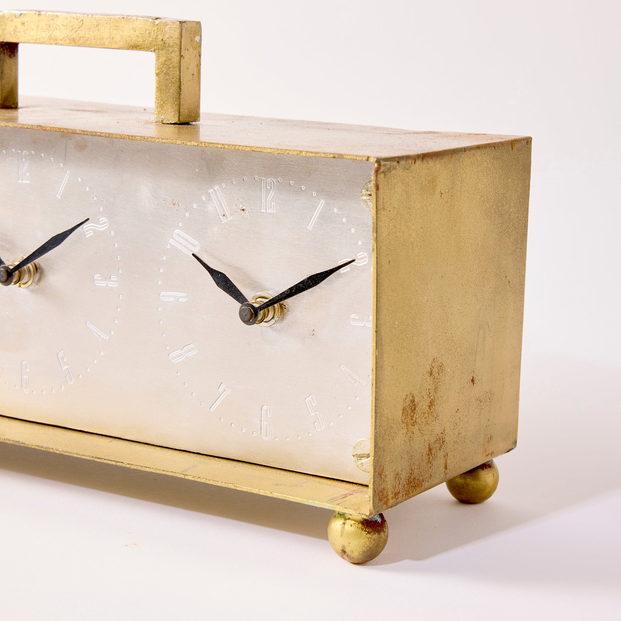 Decorative clock with gold frame and black hands on a white background