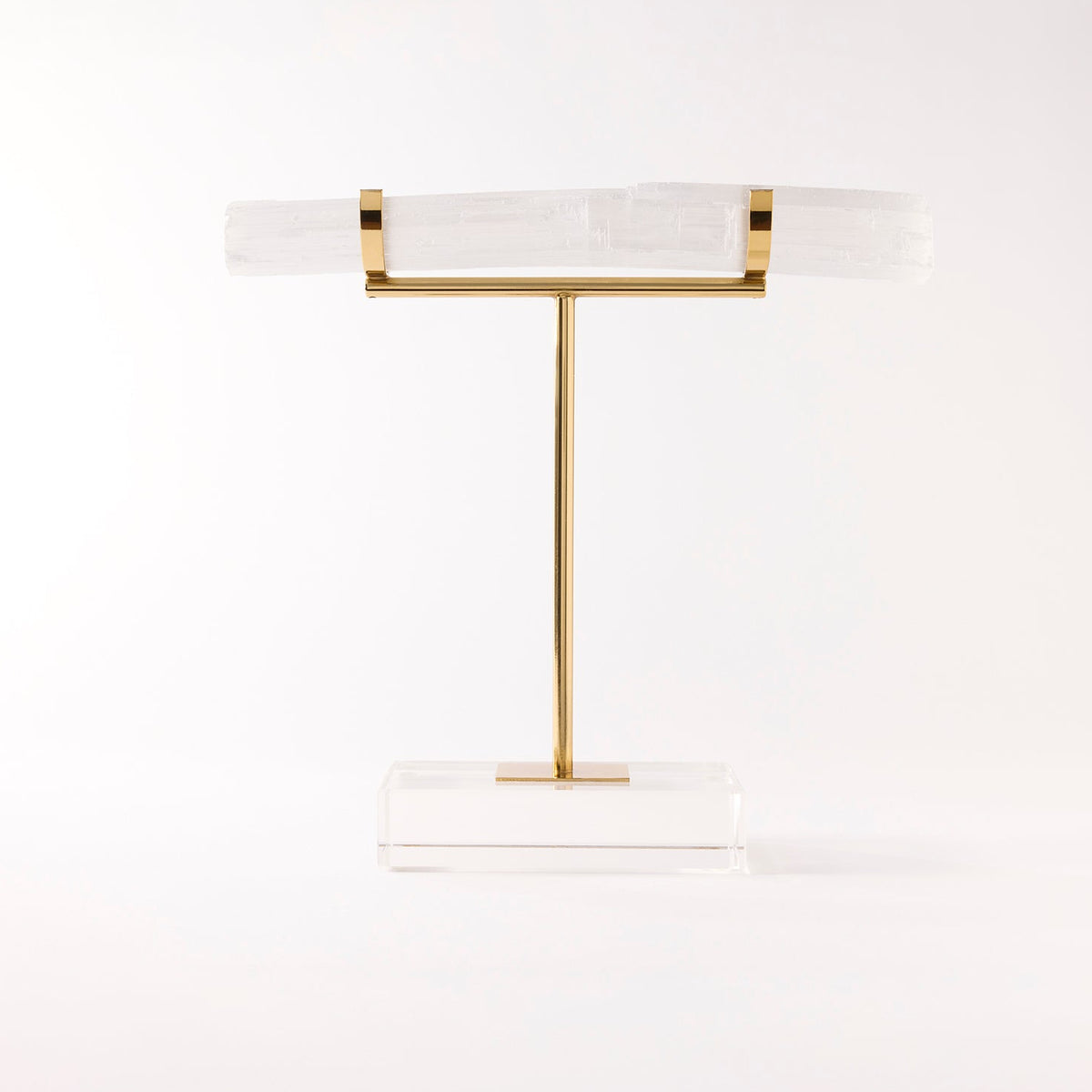 Decorative stand with gold and white design on a light gray background