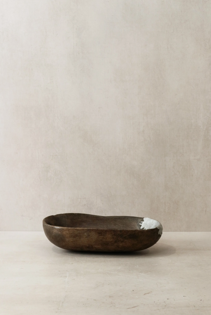 Brown ceramic bowl on a beige surface with a beige background