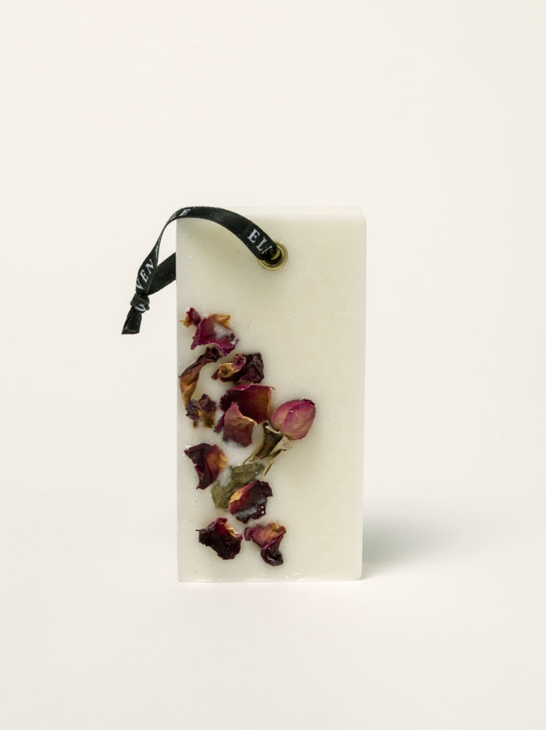 Rectangular white pouch with dried flowers on a white background