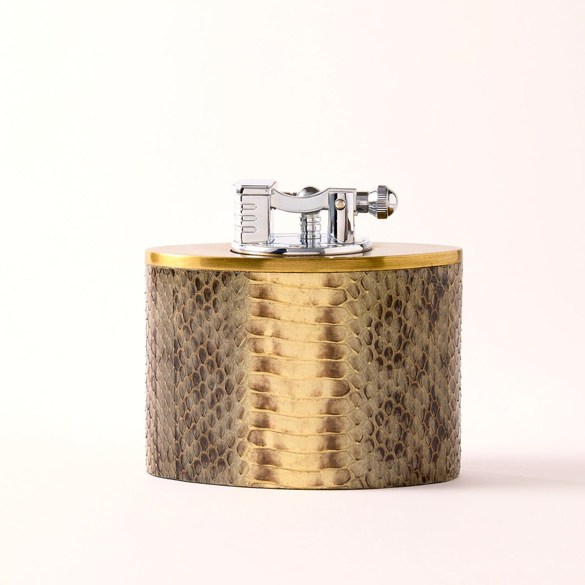 Oval oversized lighter in snakeskin with brass accent, front view