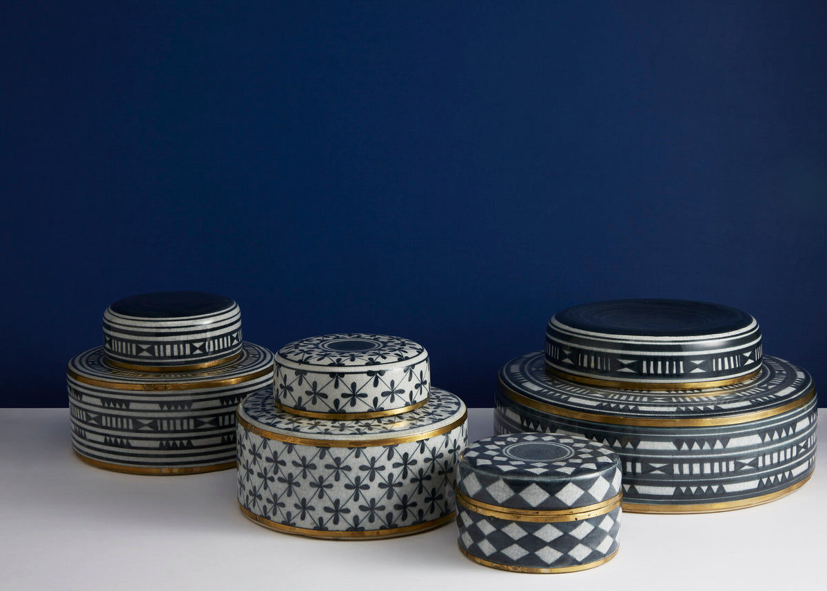 Set of decorative boxes with geometric patterns on a dark blue background