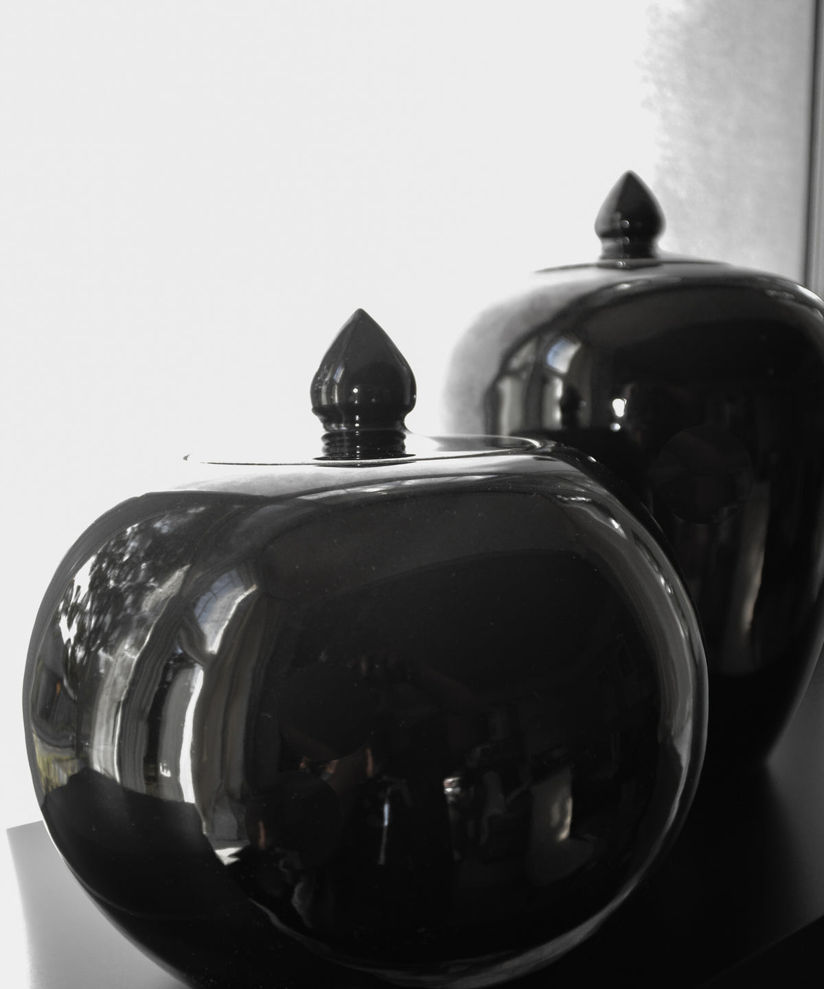 two black jars on white background