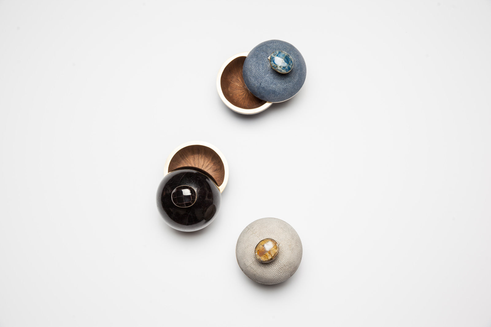 Set of small round containers with lids on a white background