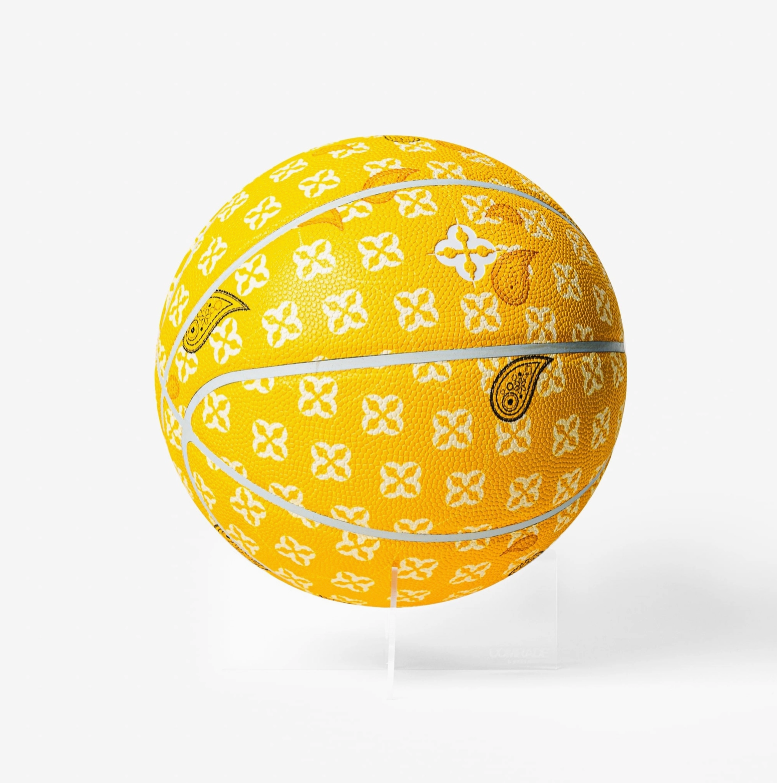 Yellow basketball with white floral pattern on a white background