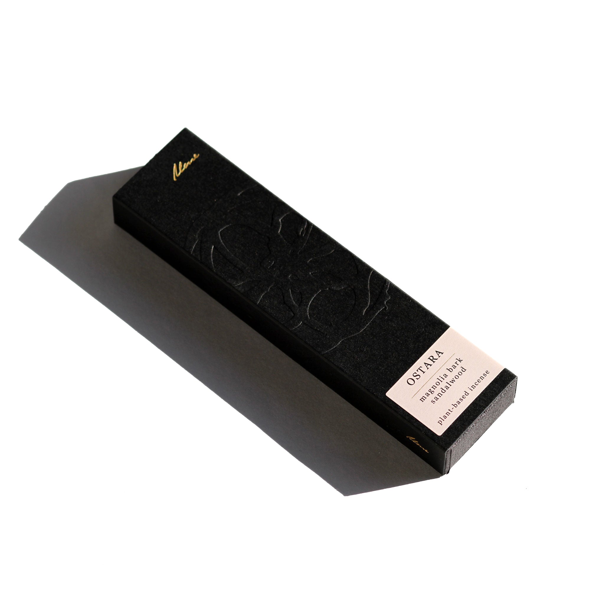 Black stone with a pink label on a white background