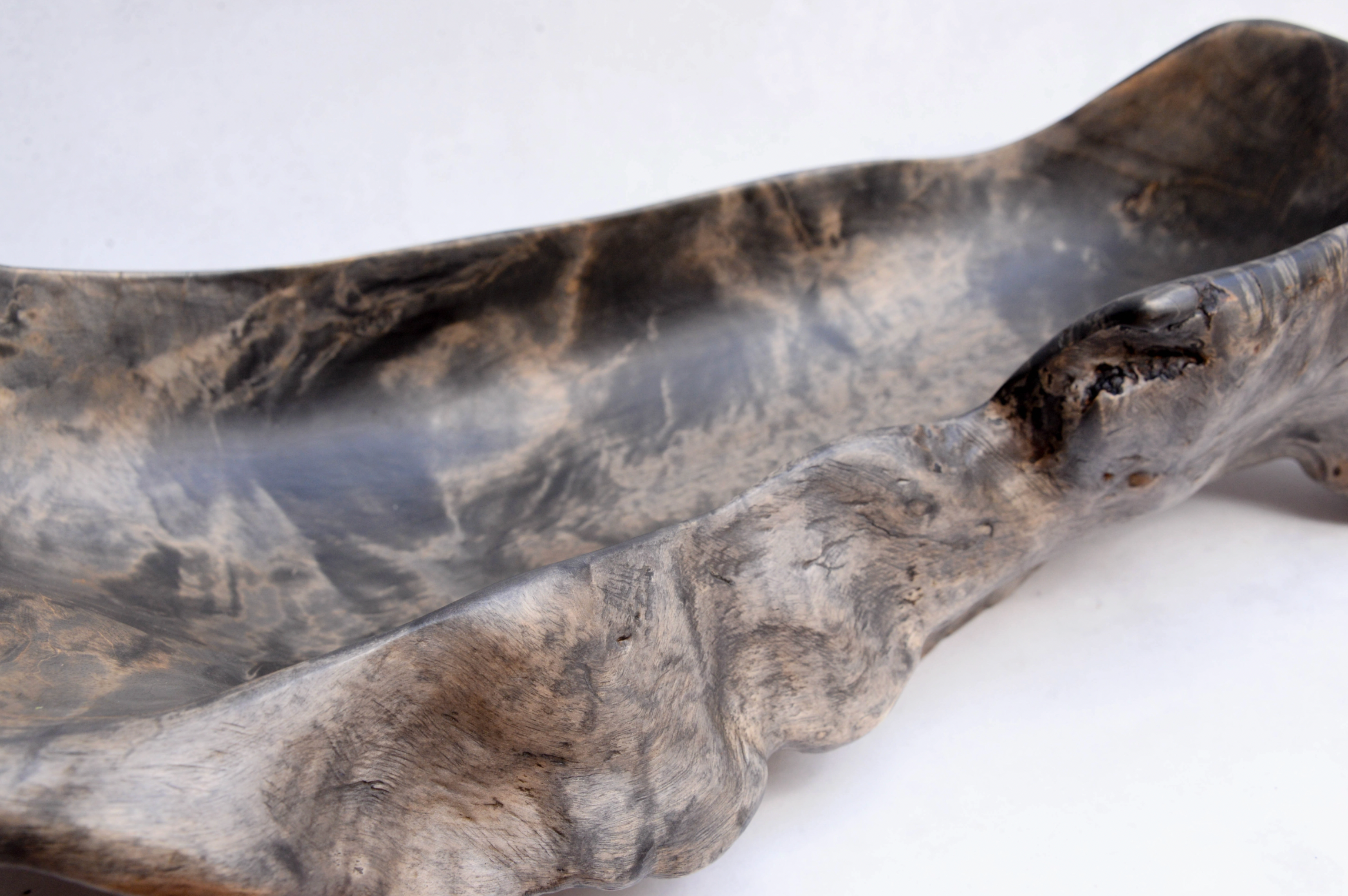 Close-up of a large, textured stone object on a white background