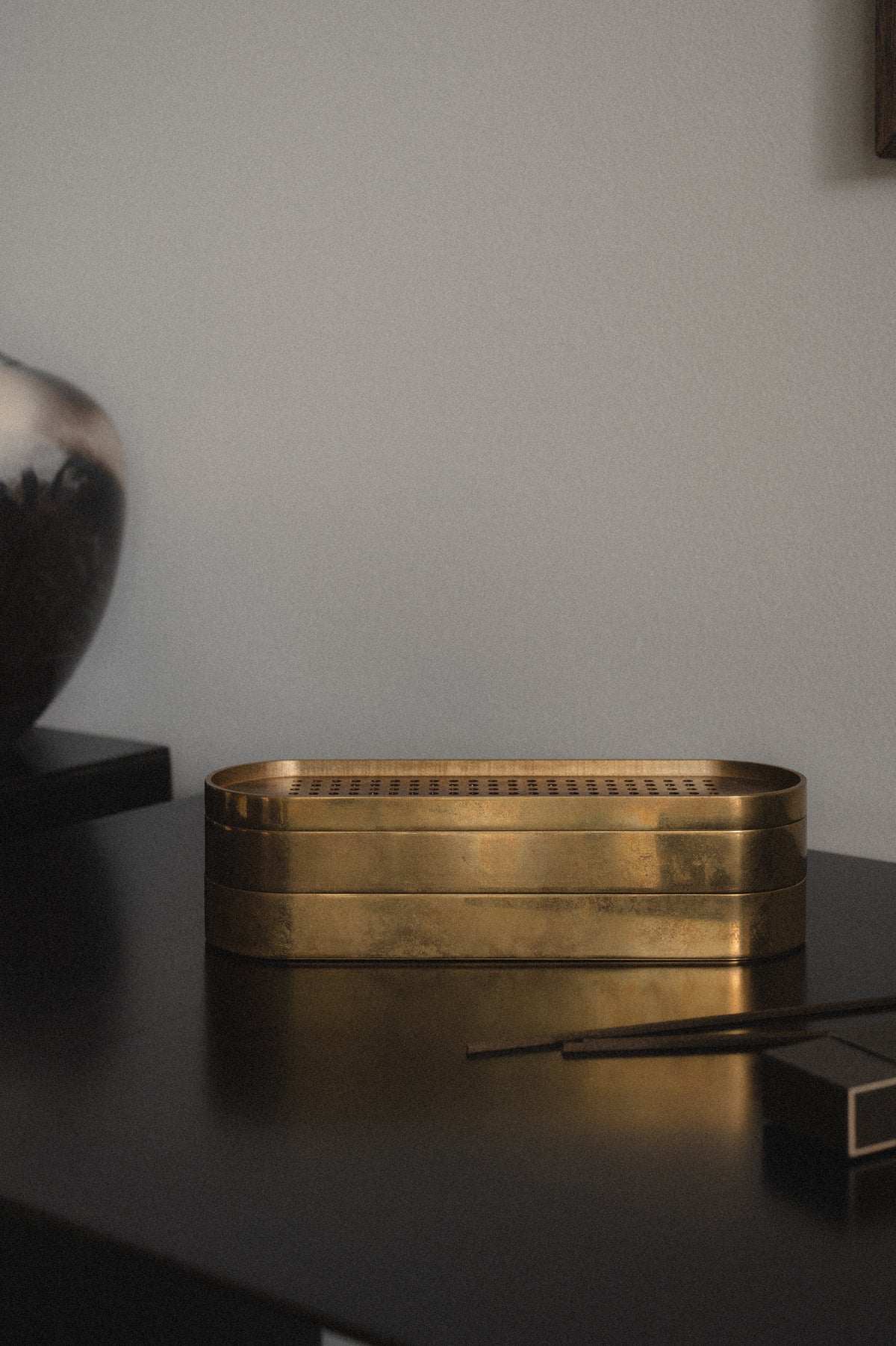 Brass Incense Burner . Brass tray on a dark surface with a gray background
