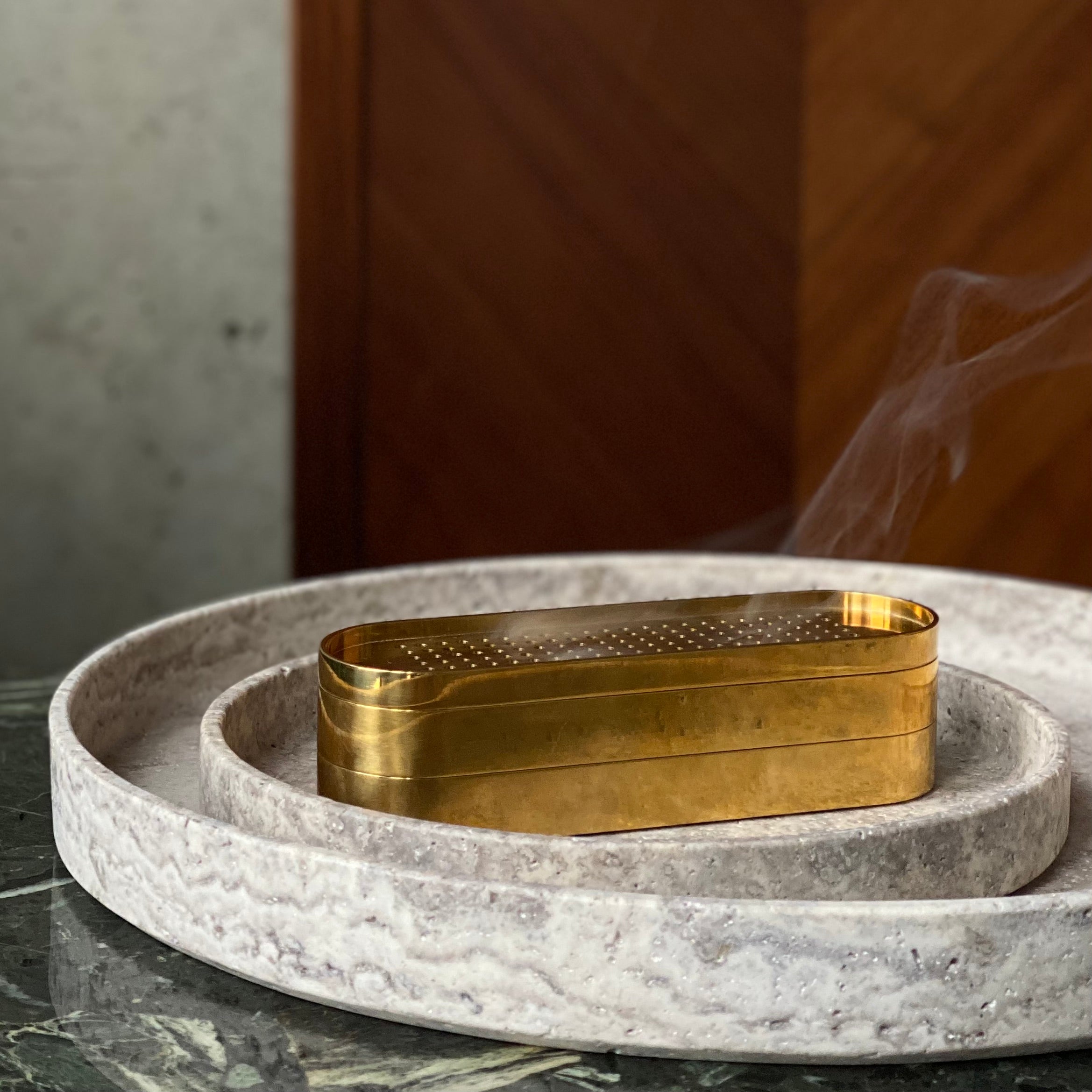 Brass Incense Burner . Gold decorative box on a stone surface with a blurred background