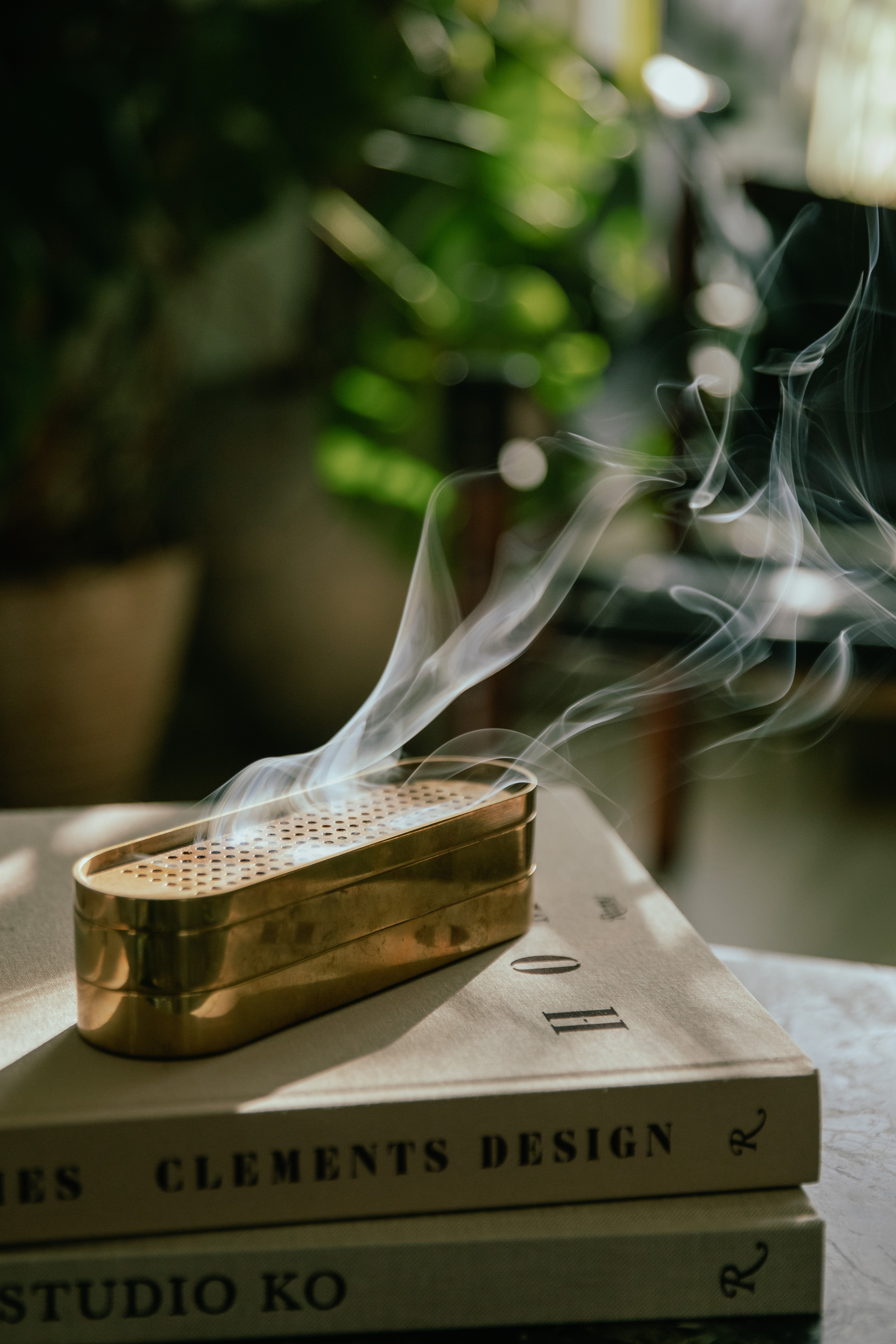 Brass Incense Burner on top of books with a blurred background
