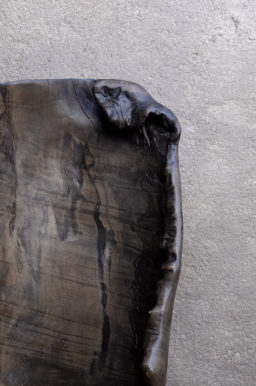 Wooden tray with a natural, dark finish on a gray surface