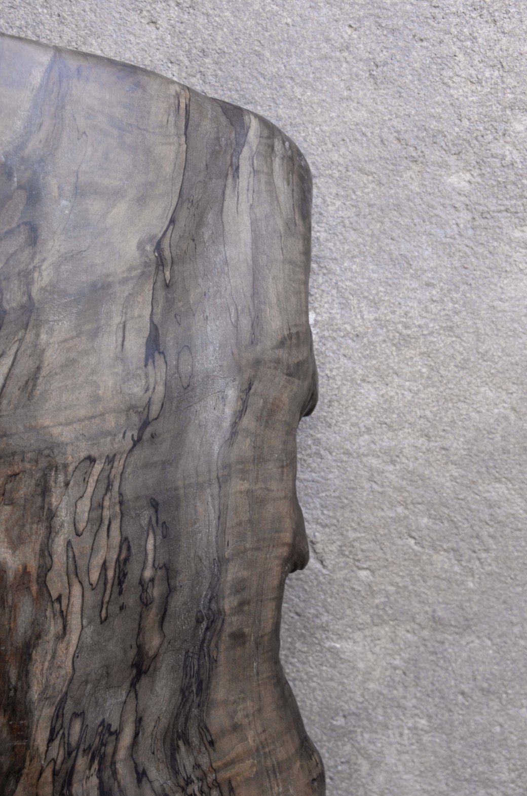 Close-up of a wooden surface with a textured gray background