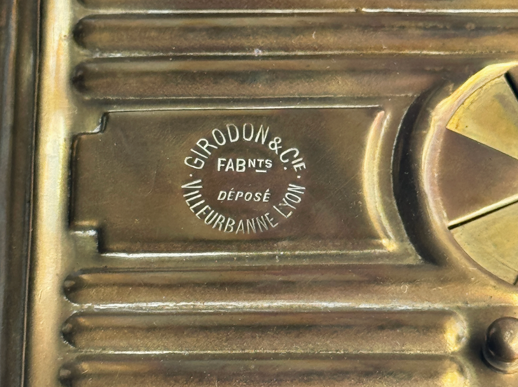 Close-up of a metallic object with 'Girodon & Cie' branding.