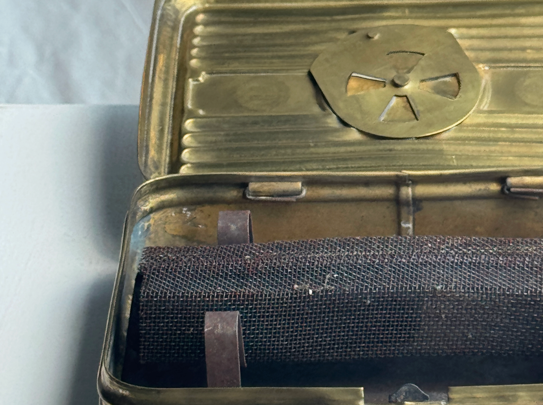 Metallic case with a radiation symbol on a white background