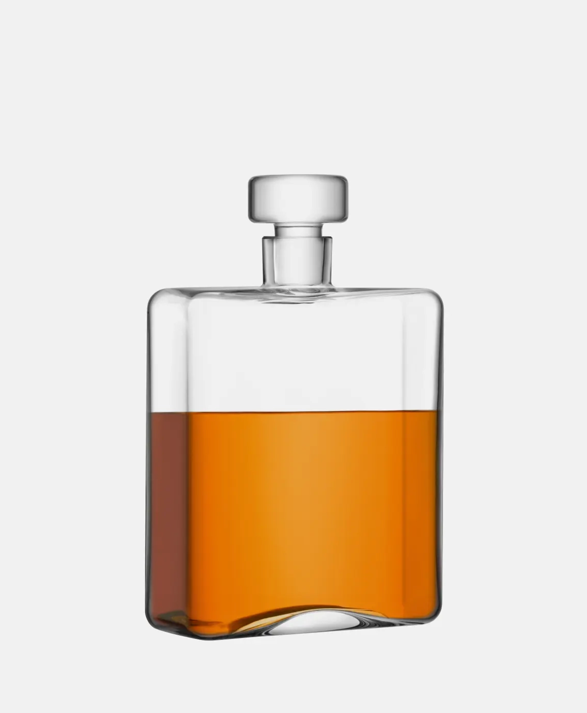 Clear glass bottle with amber liquid on a white background