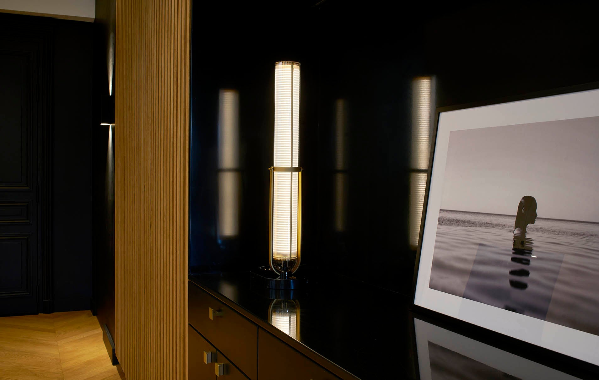 Modern interior with a large flat-screen TV displaying an image of a person standing on water.