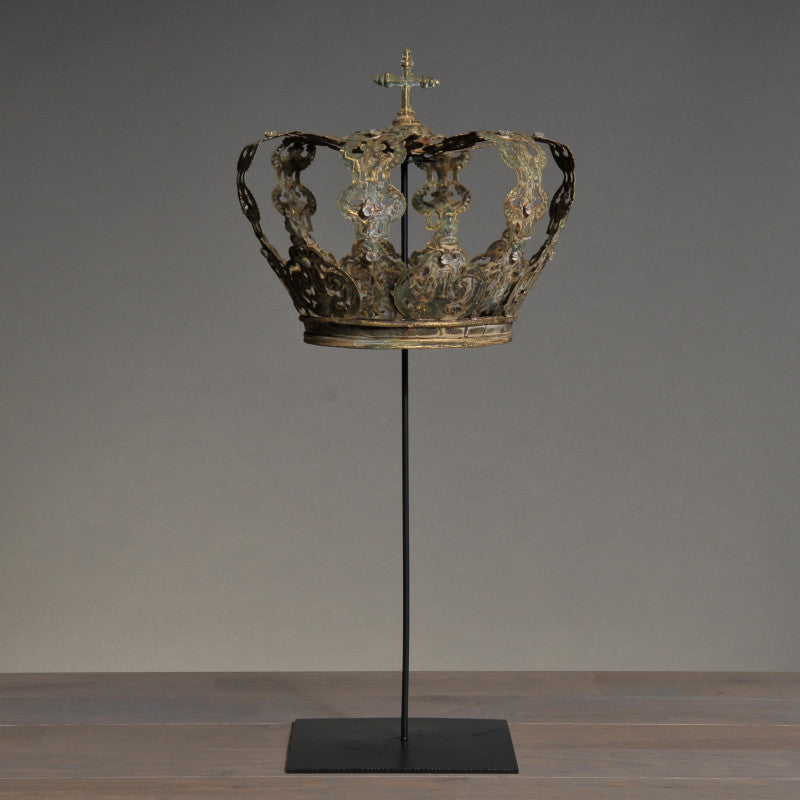 Decorative crown on a stand against a gray background