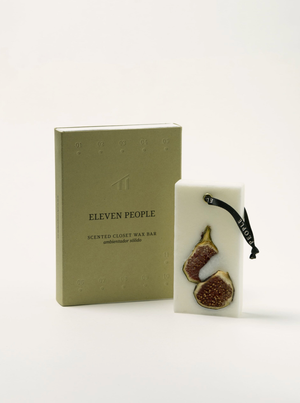 Scented candle wax bar with fig design next to a green box labeled 'Eleven People' on a white background