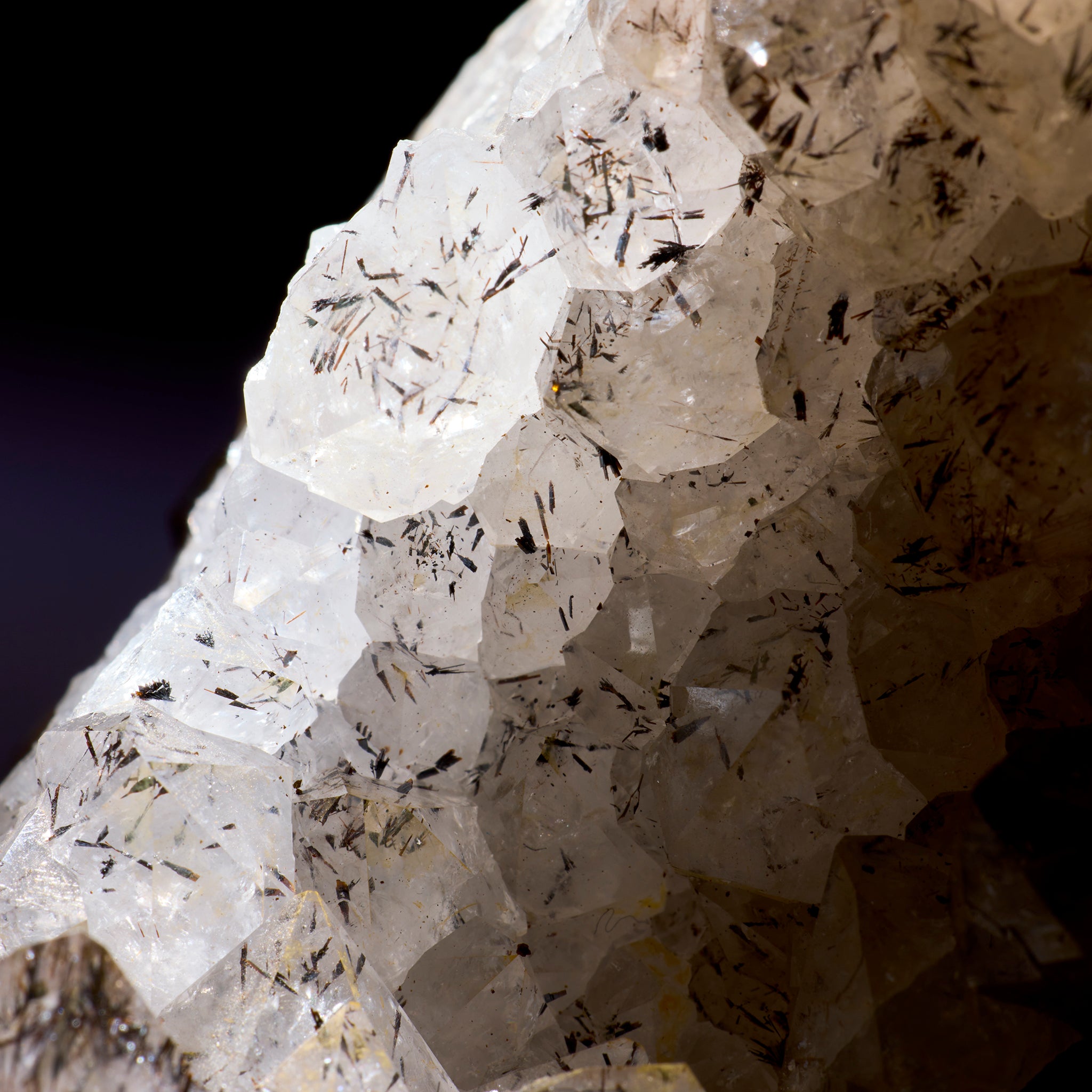 Close-up of a crystal formation with visible minerals on a dark background