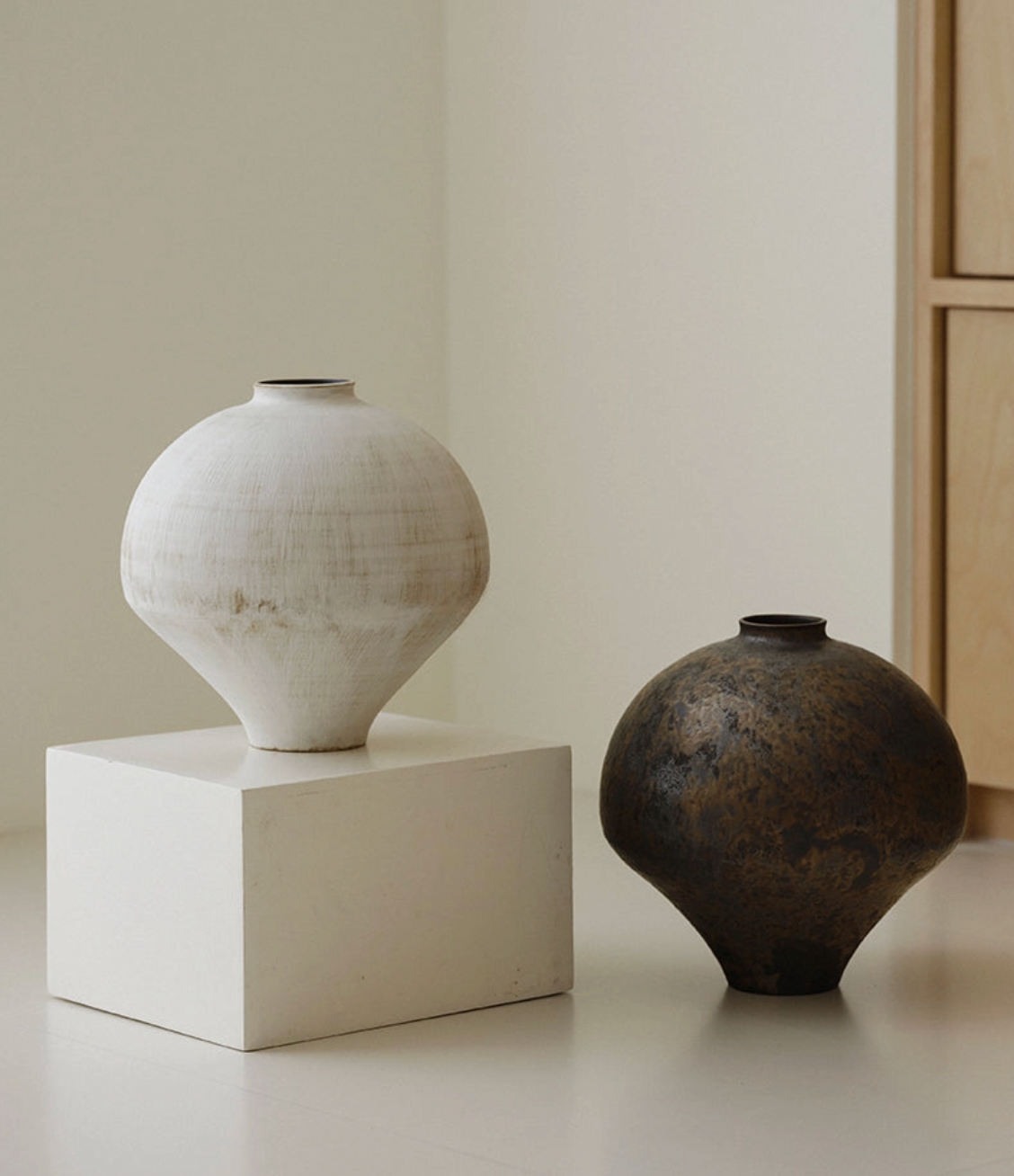 white and brown vase on pedestal