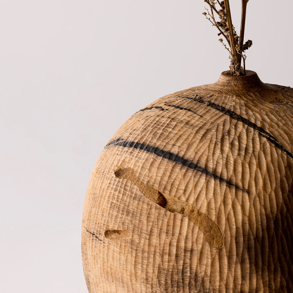 Textured vase with natural patterns on a plain background