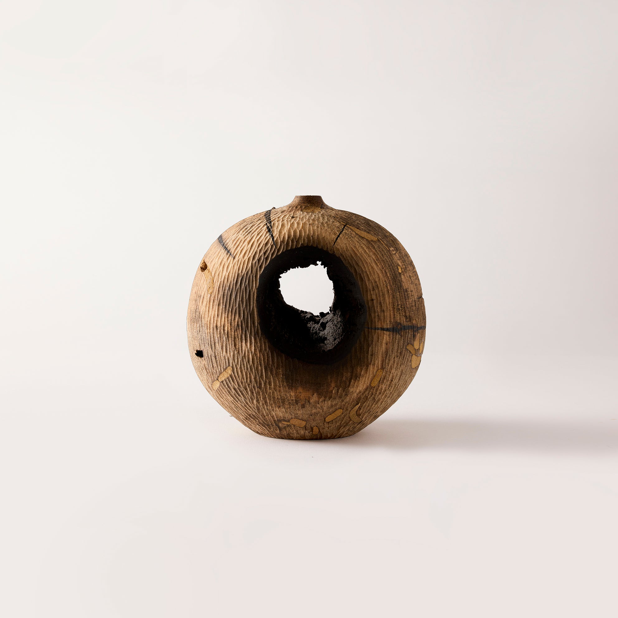 Wooden vase with a textured surface on a white background