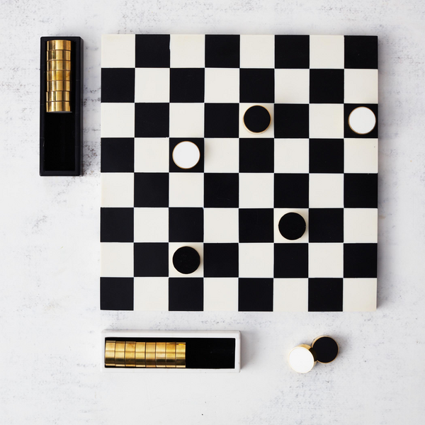 Checkers gameboard on white background with gold chips