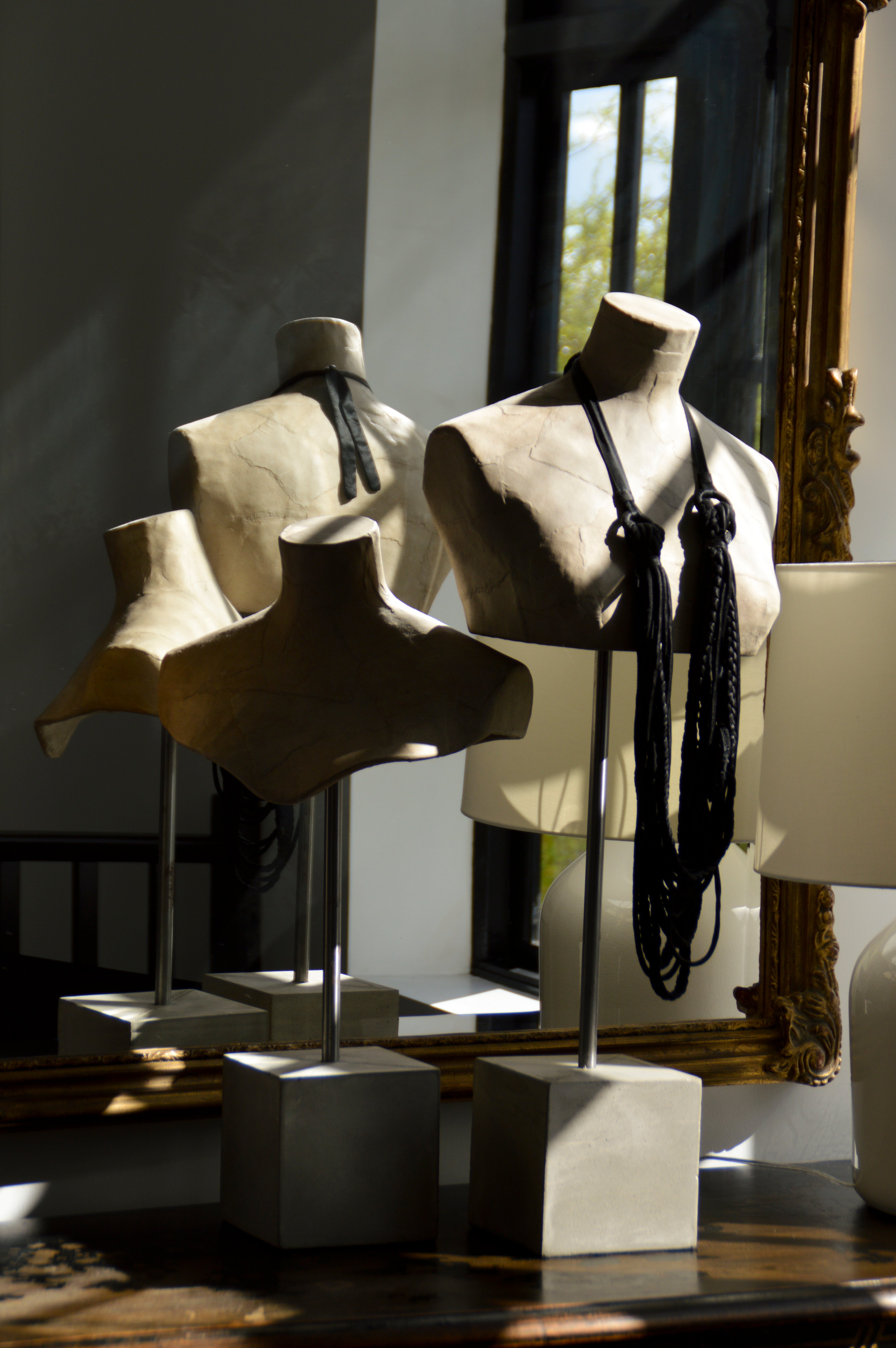 Model shoulder busts with black necklace