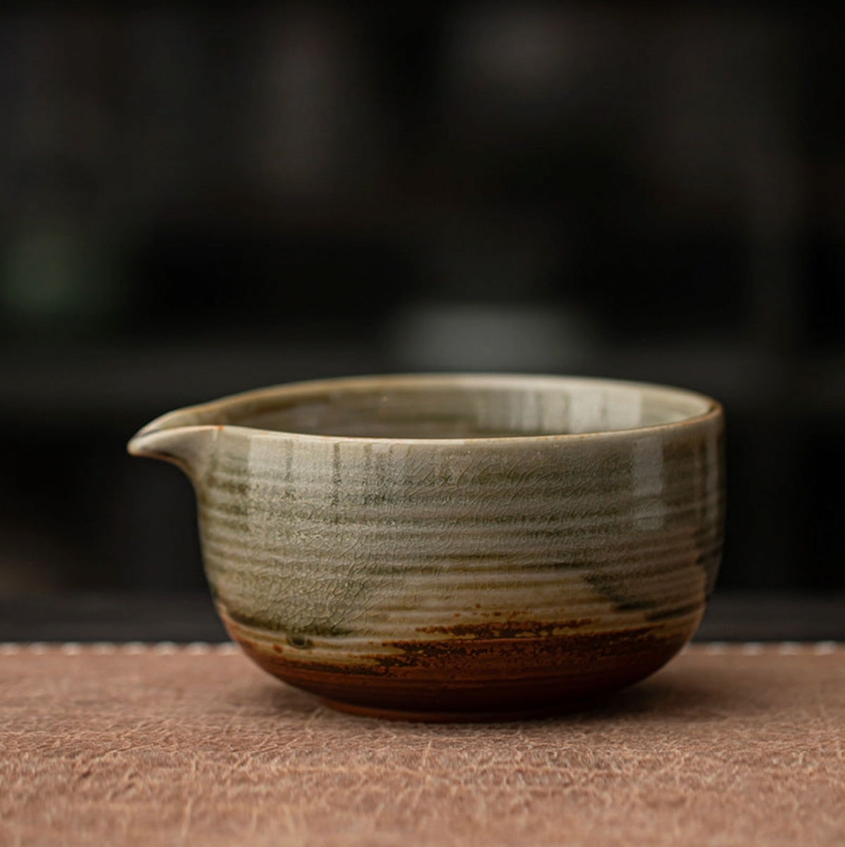 Ceramic teapot with a textured surface on a wooden surface