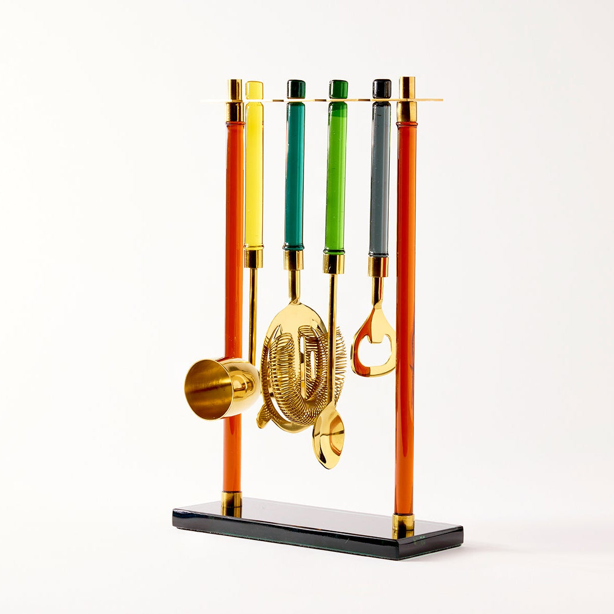 set of cocktail tools on a stand