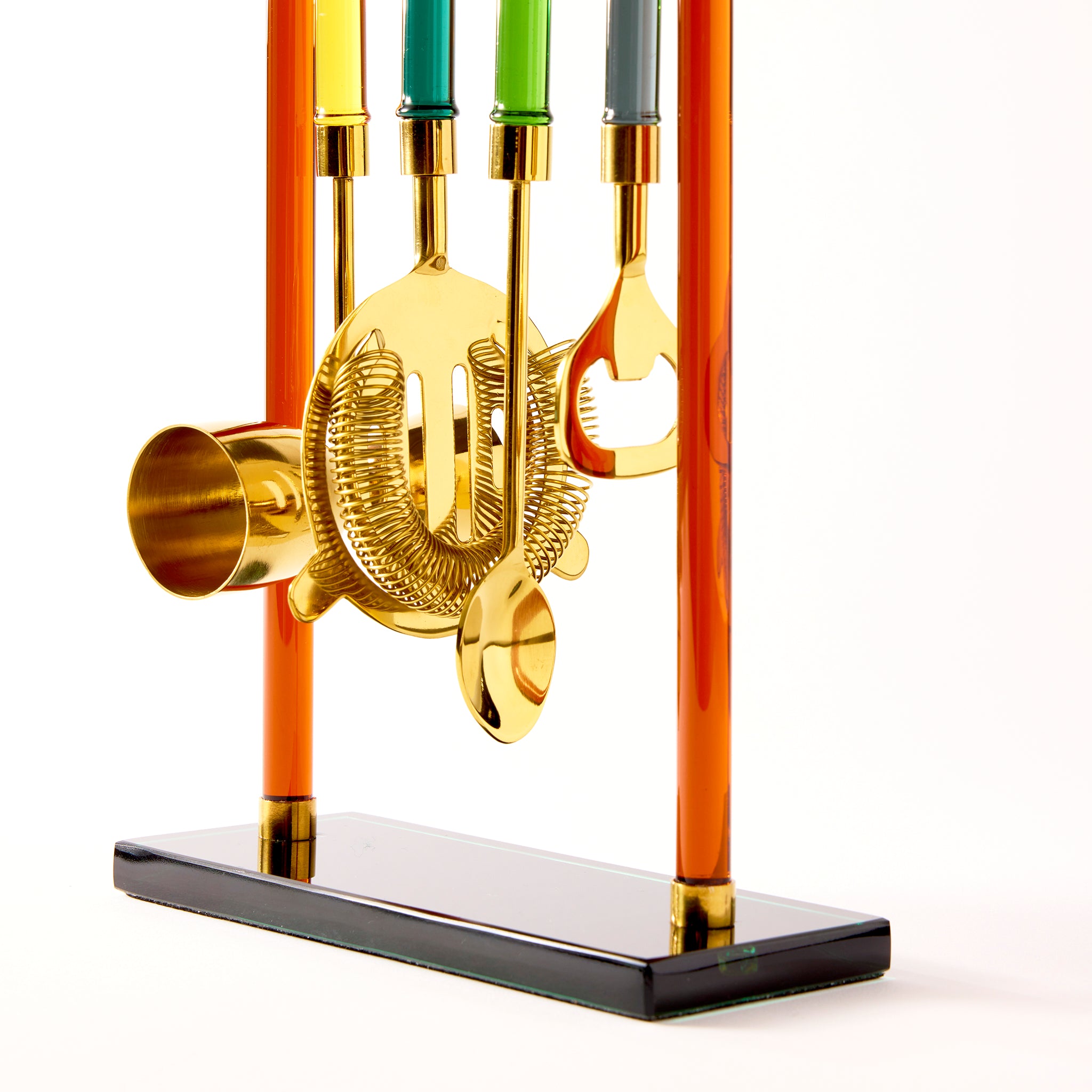 set of cocktail tools on a stand