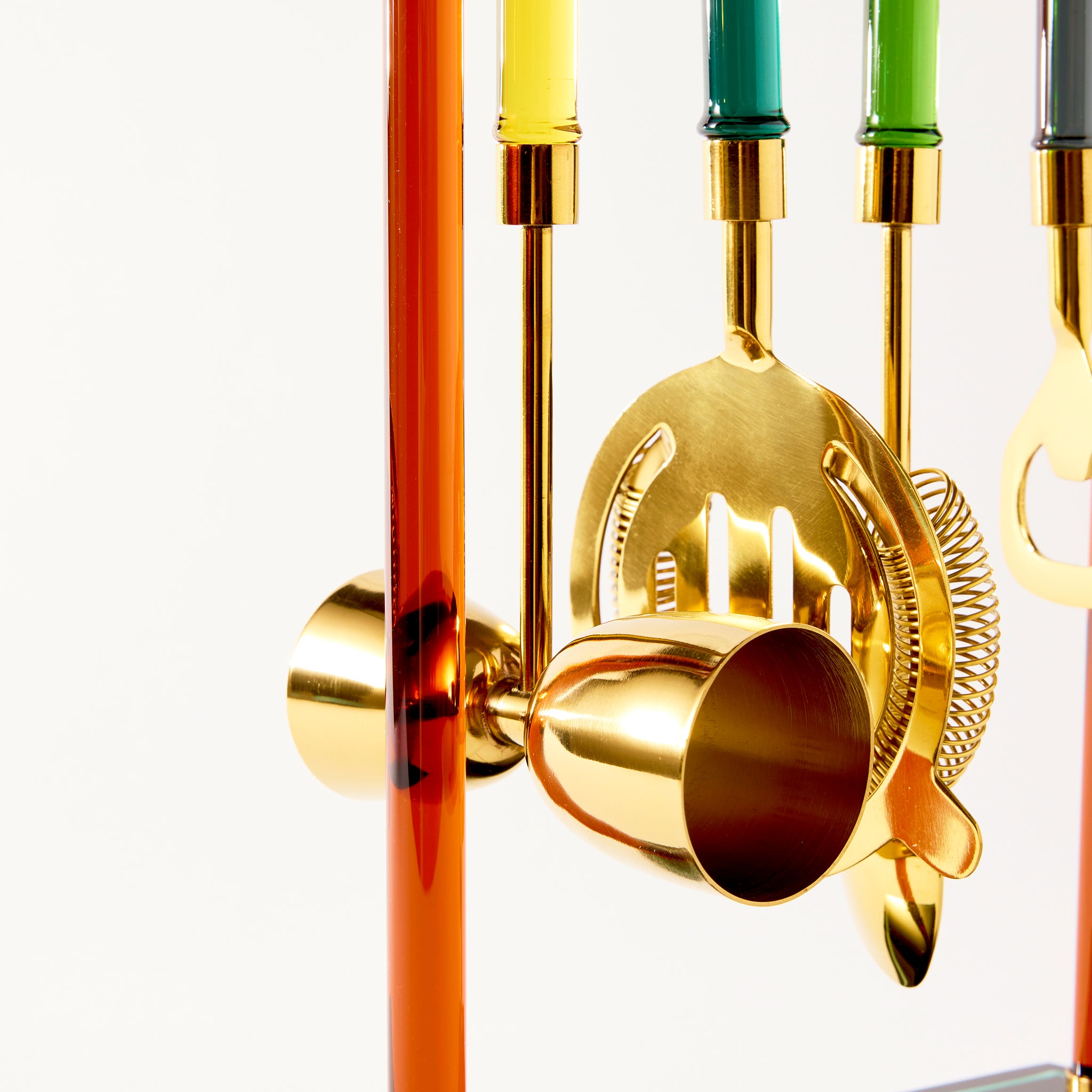 set of cocktail tools on a stand