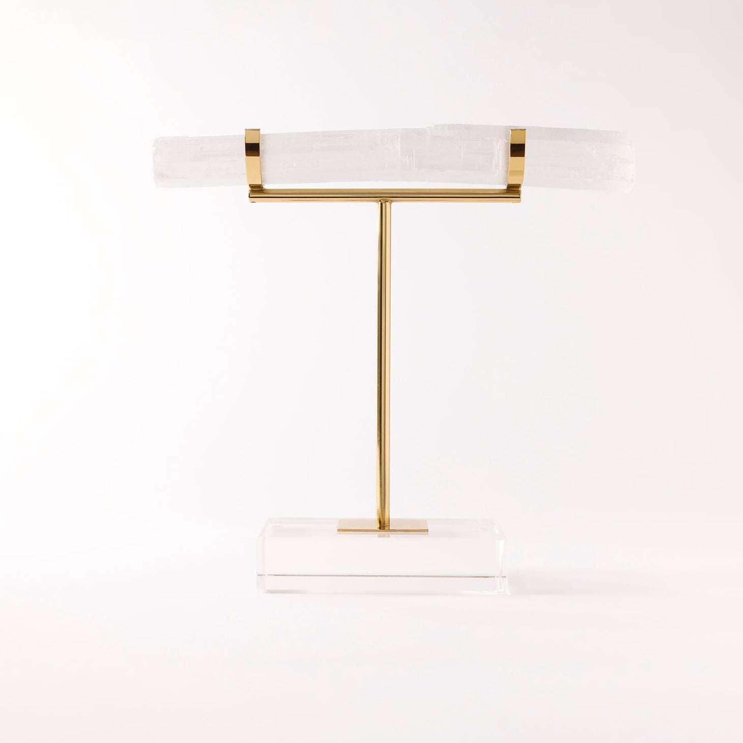 Decorative stand with gold and white design on a light gray background