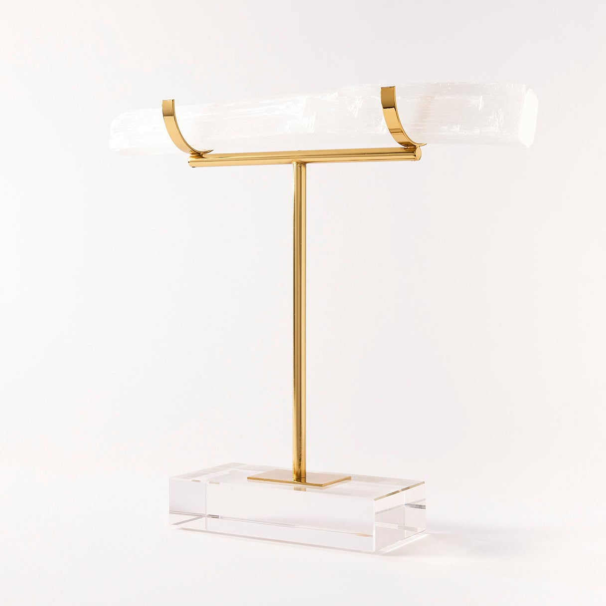 Gold T-shaped jewelry stand on a white background