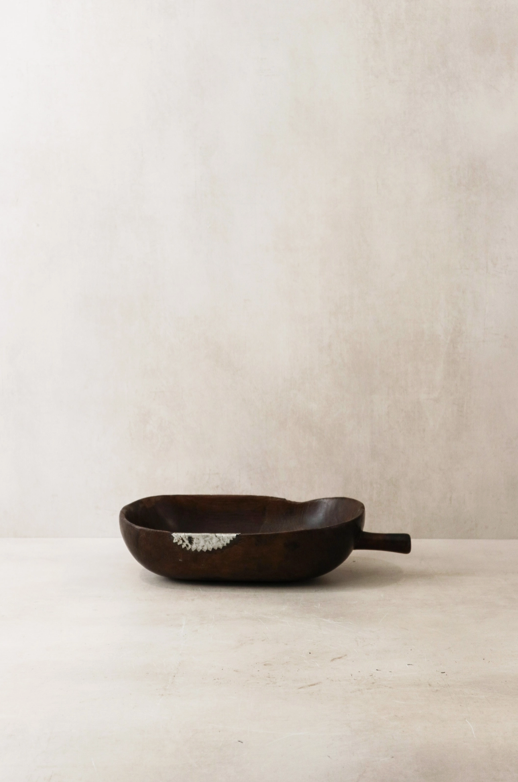 Black cast iron skillet on a light beige background