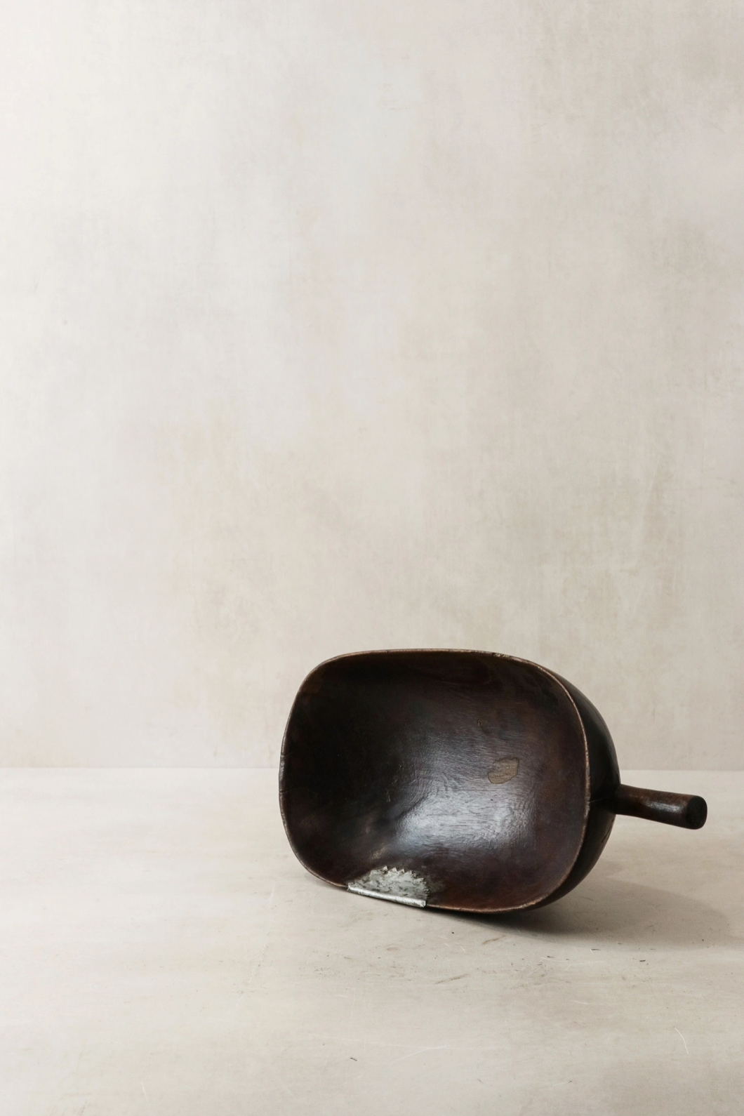 Black ceramic scoop on a beige background