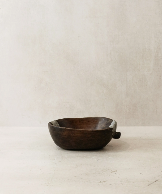 Wooden bowl on a light beige background
