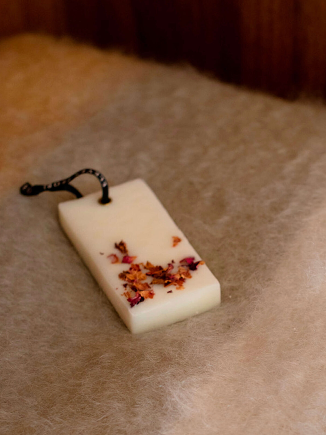Rectangular soap with dried flowers on a textured surface