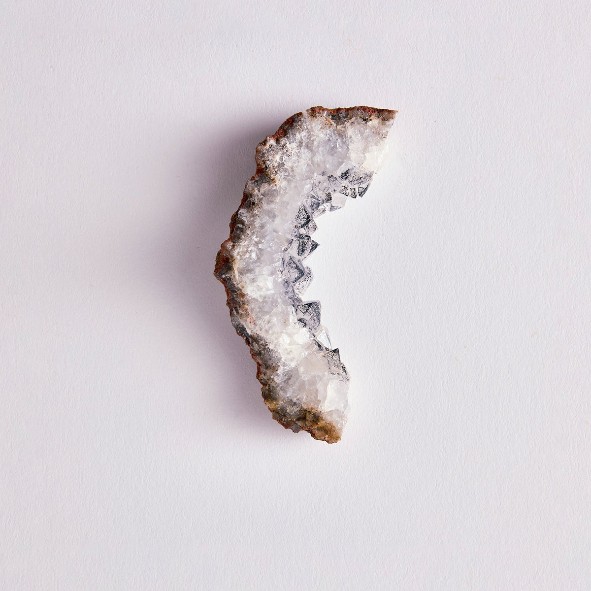 Geode crystal on a light gray background
