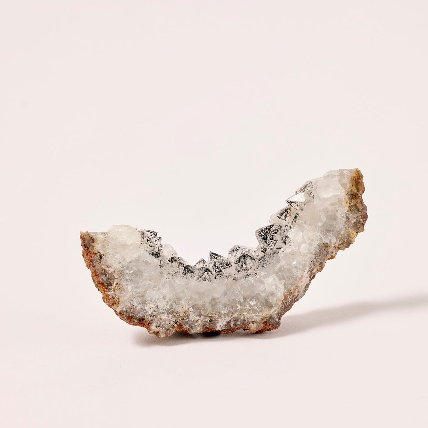 Mineral sample on a light pink background