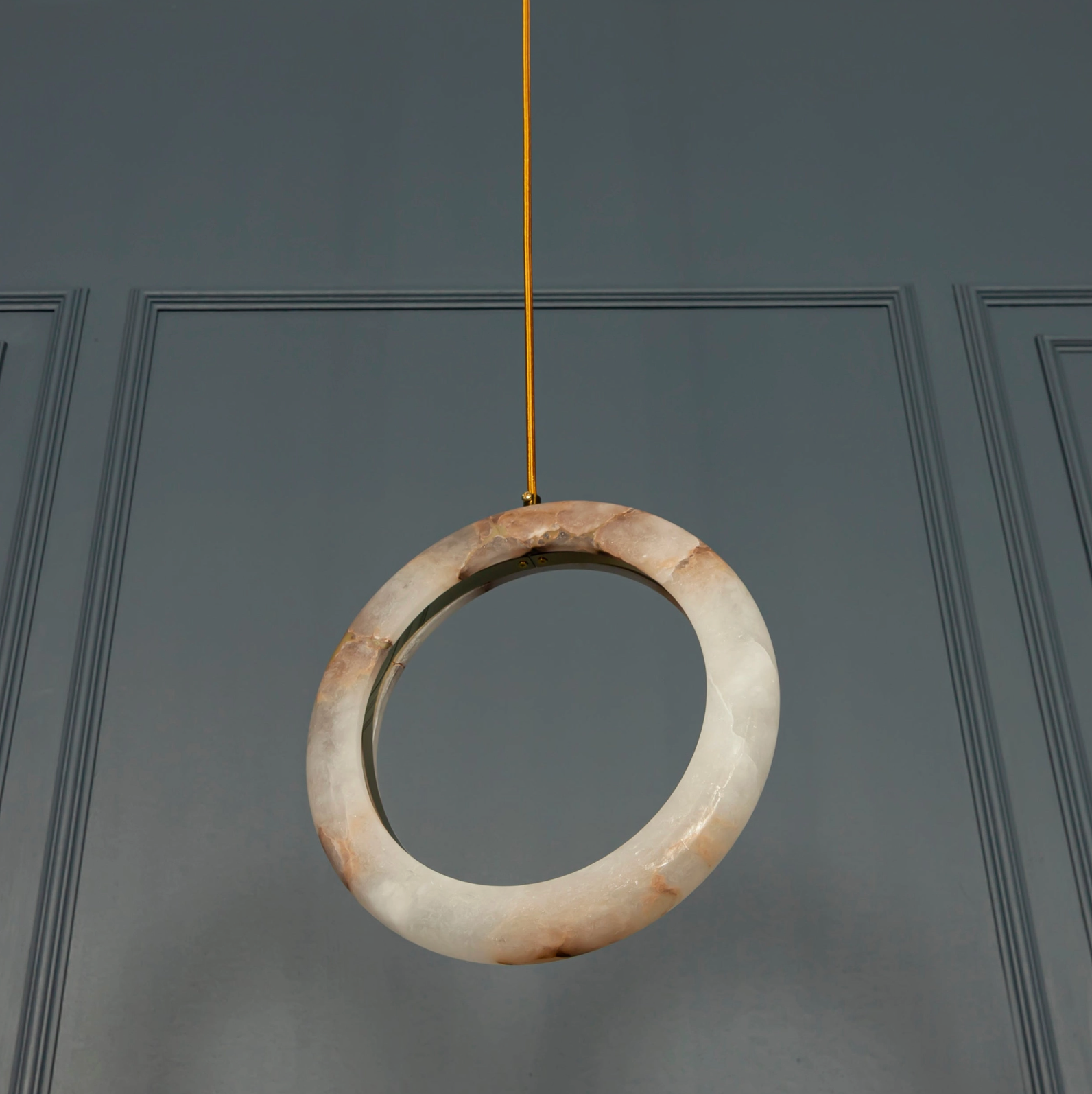 Decorative stone ring hanging against a dark gray door