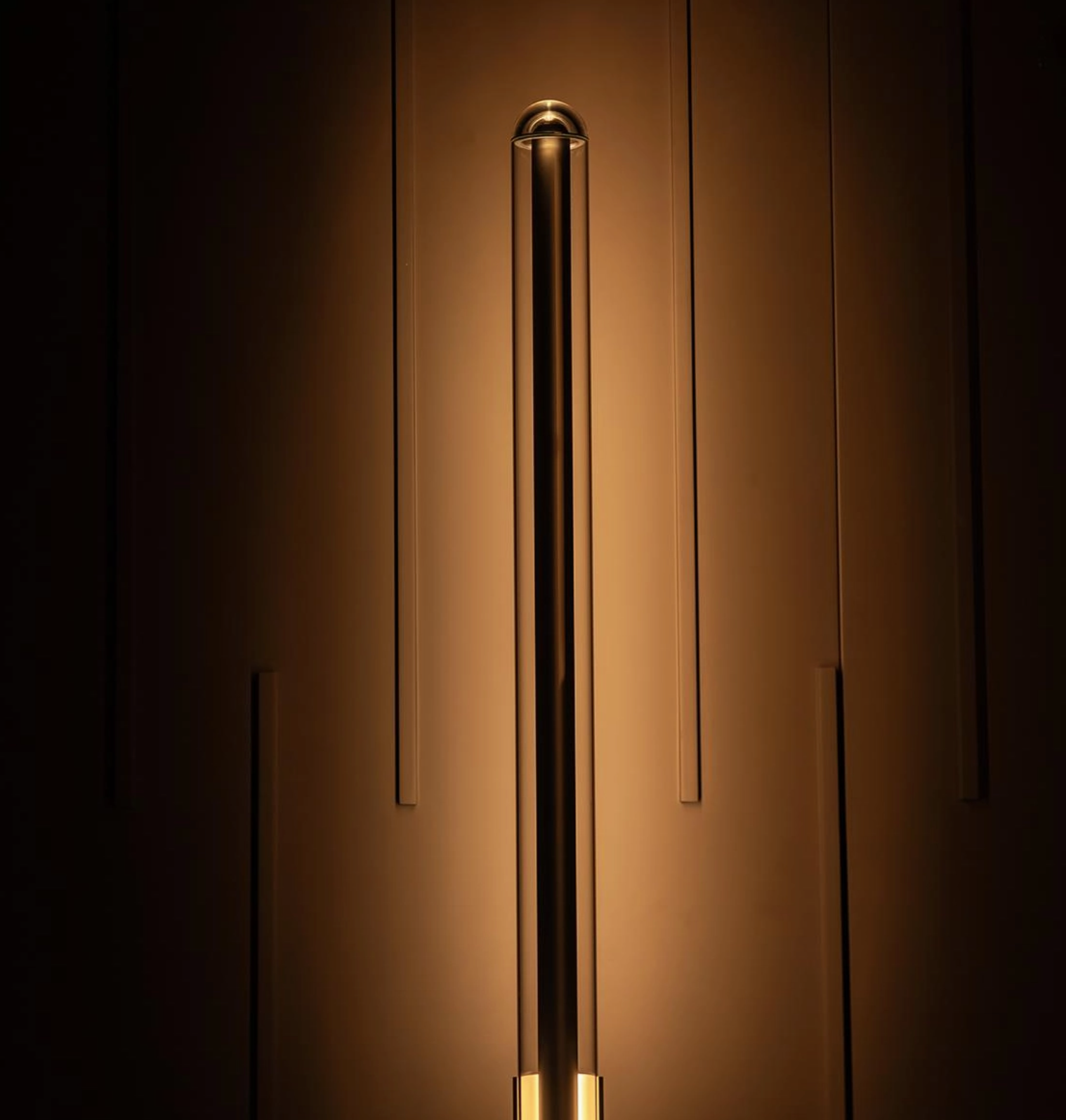 Close-up of a modern wall light fixture on a dark background