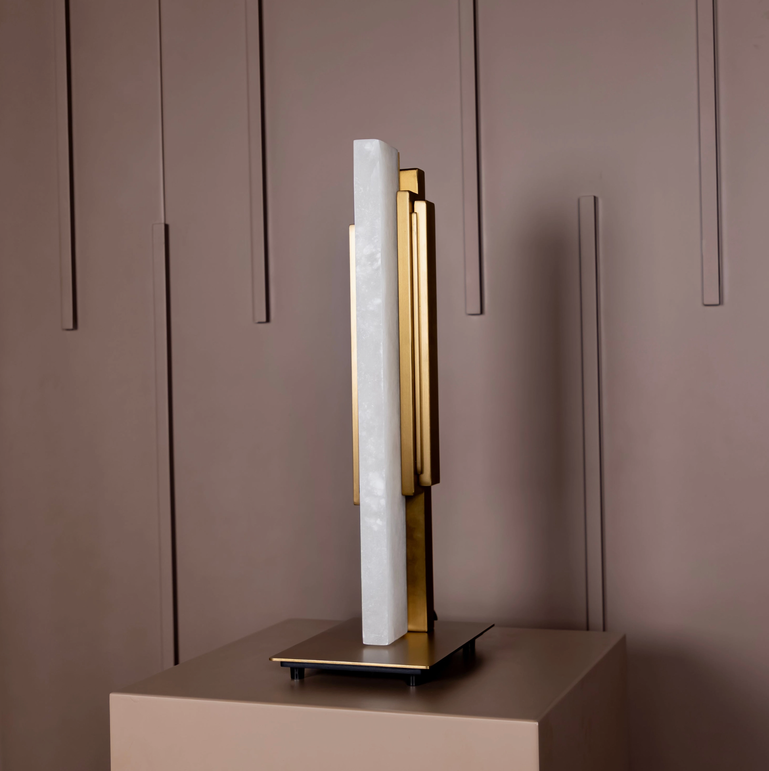 Decorative sculpture with gold and white elements on a neutral background