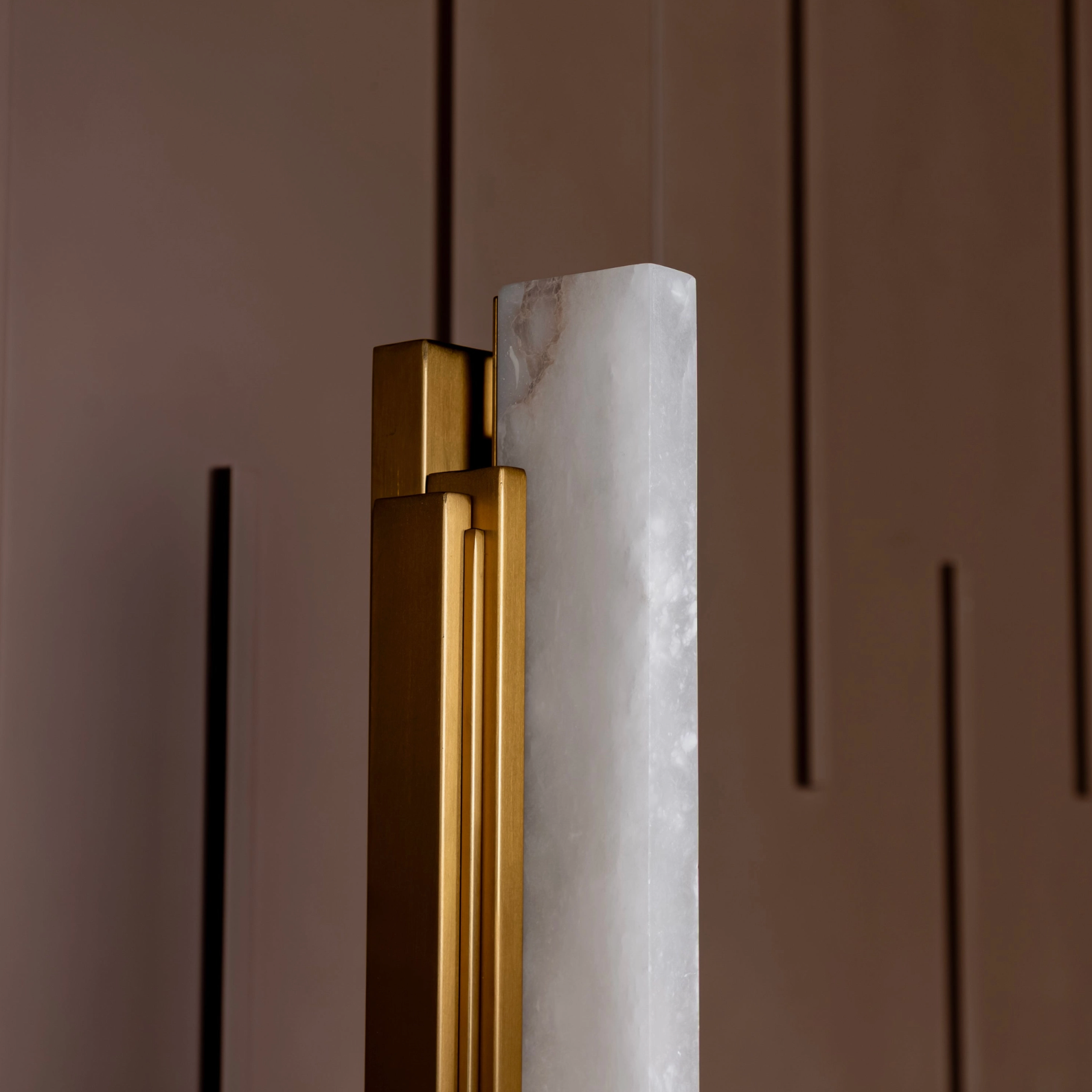 Gold handle on a door with marble finish