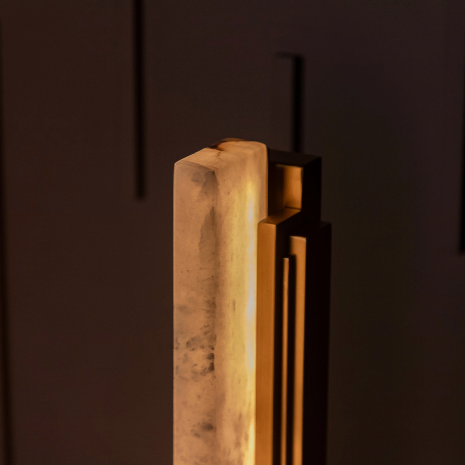 Decorative wall sconce with a warm glow on a dark background