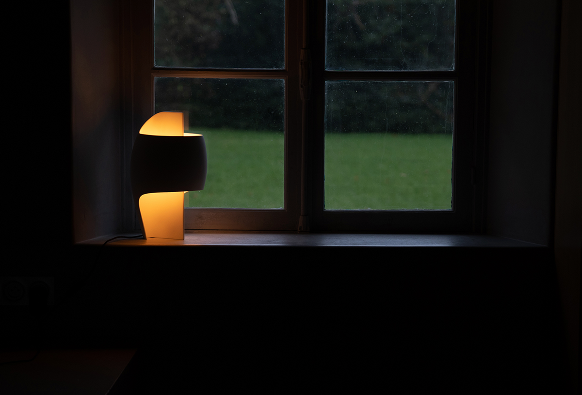 Lamp on a windowsill with a dark background