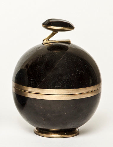 Decorative object with black marble-like surface and gold accents on a white background