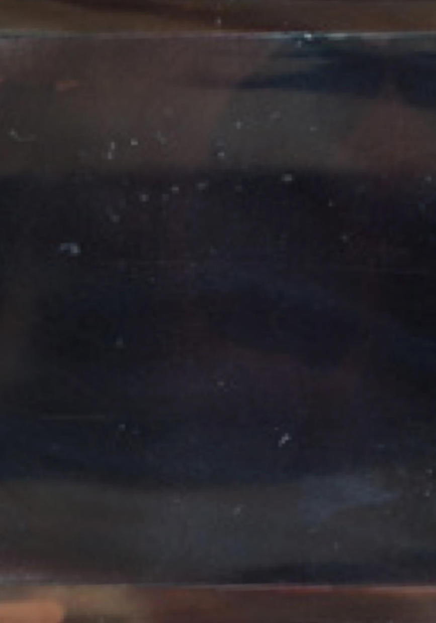 Dark, textured surface with a reflective quality